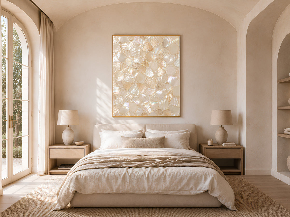 Ivory champagne mosaic print in a gold frame above a bed in a neutral, arched-window bedroom