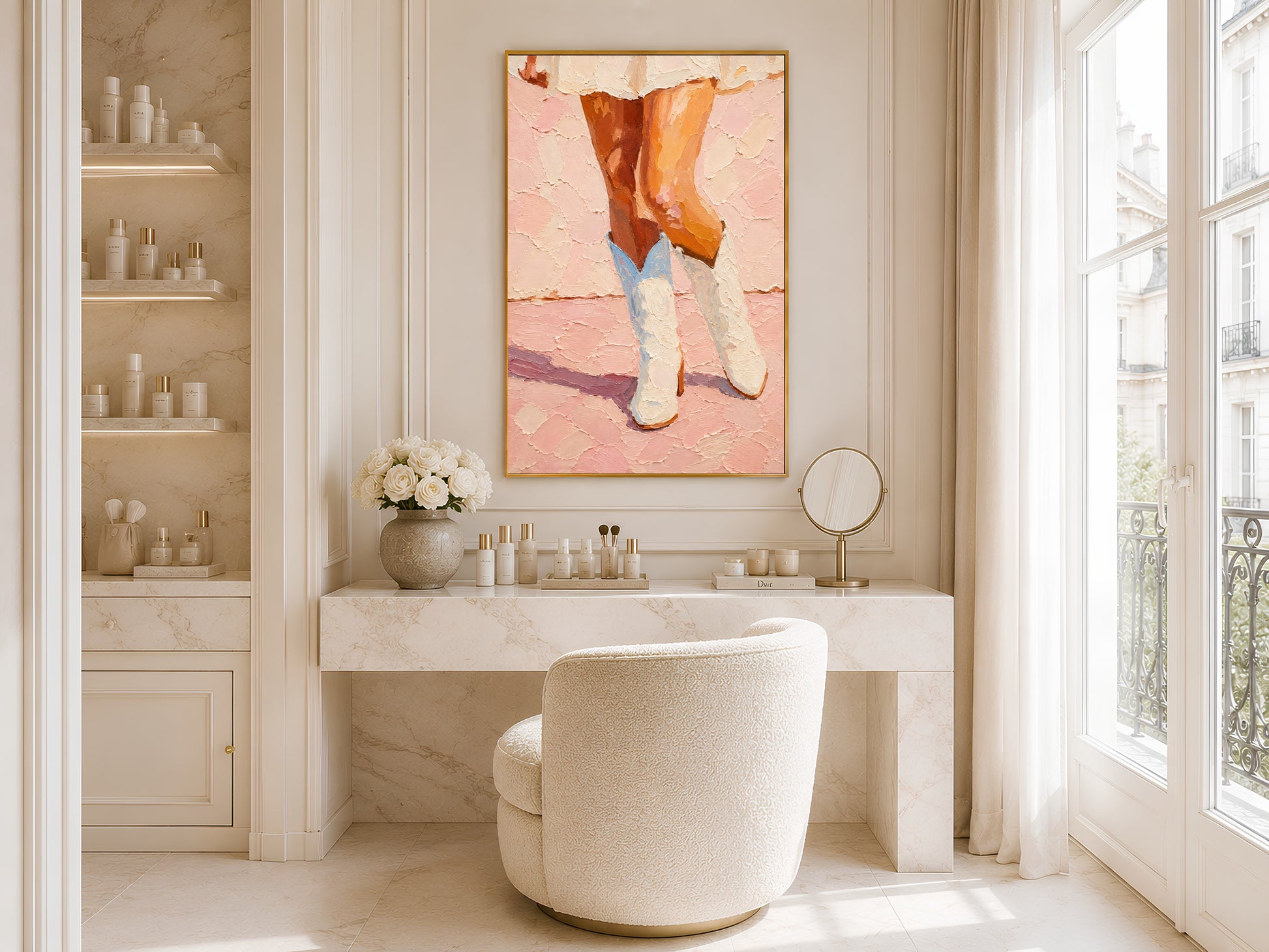 Framed cowgirl boots wall art displayed in a bright white bathroom with round mirror, vanity shelving, and freestanding soaking tub by large window

