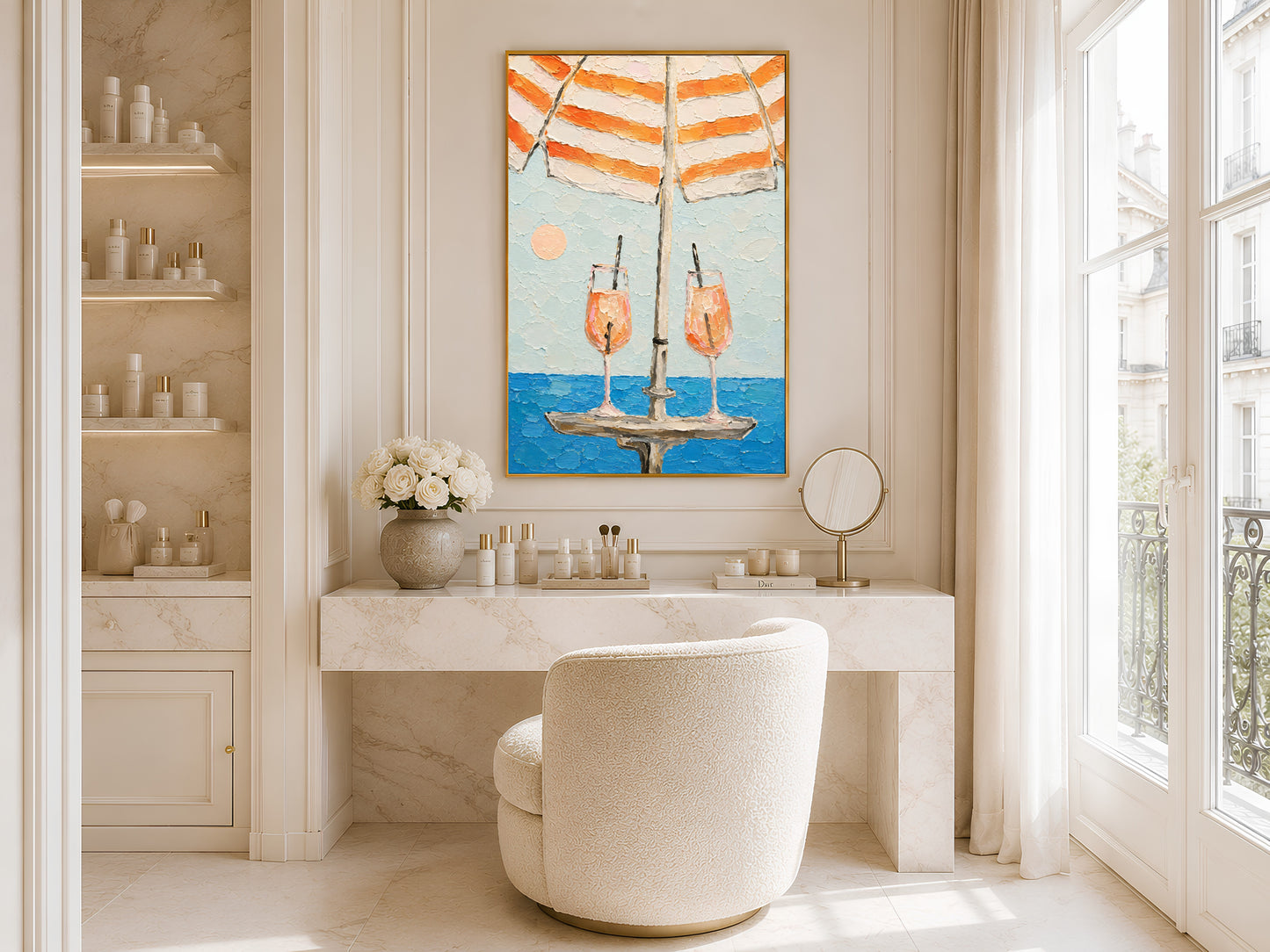 Framed aperol spritz beach umbrella print displayed in a bright white bathroom with round mirror, vanity shelving, and freestanding soaking tub

