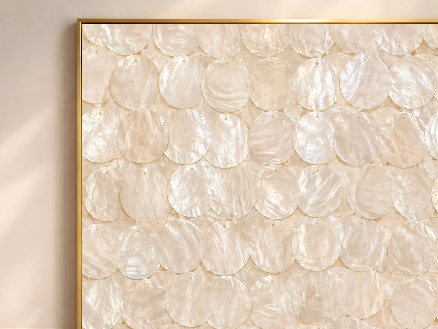 Close-up of the capiz shell wall art print showing the full overlapping iridescent ivory and cream shell disc pattern with subtle pearlescent shimmer and warm neutral texture
