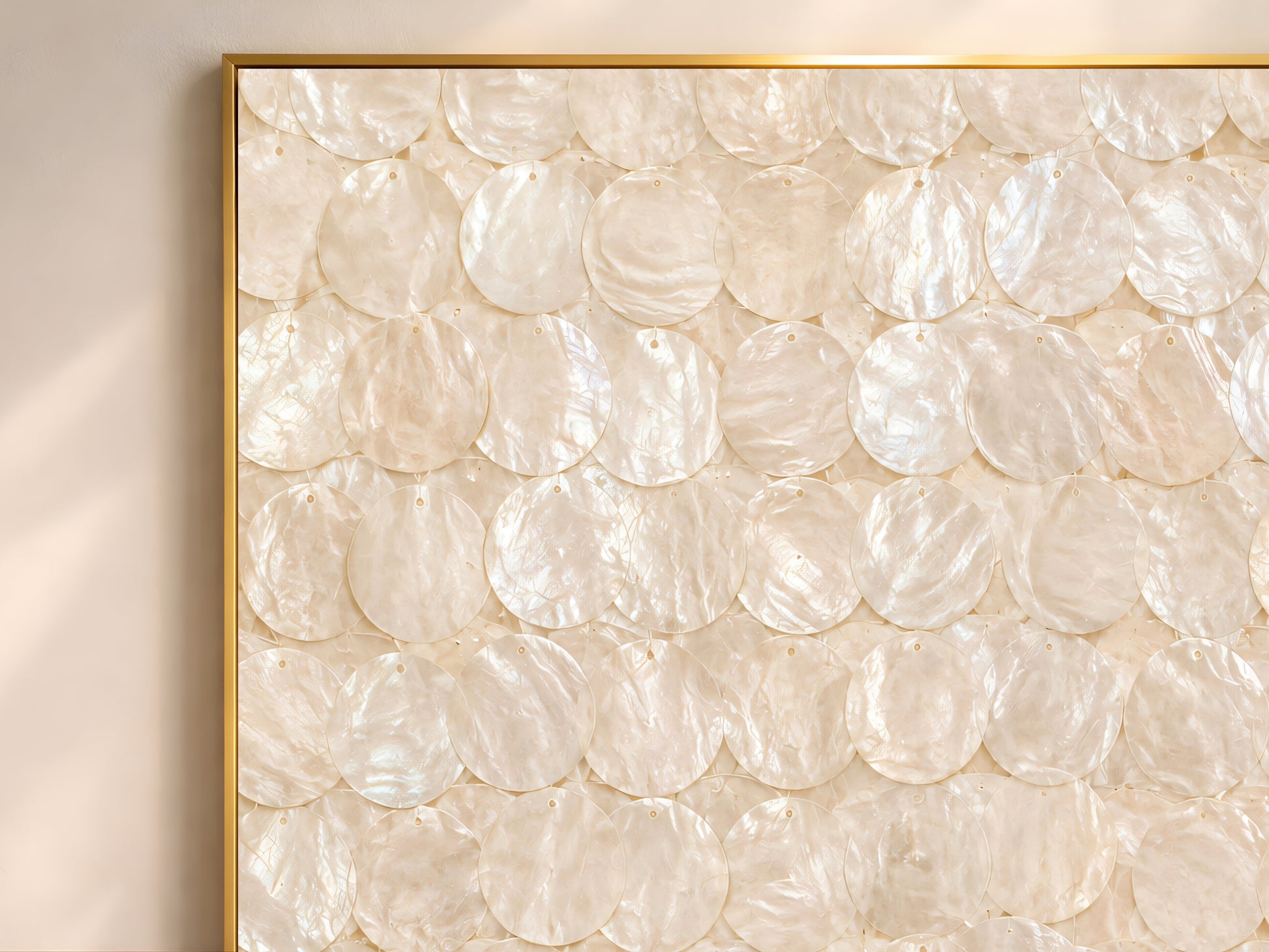 Close-up of the capiz shell wall art print showing the full overlapping iridescent ivory and cream shell disc pattern with subtle pearlescent shimmer and warm neutral texture
