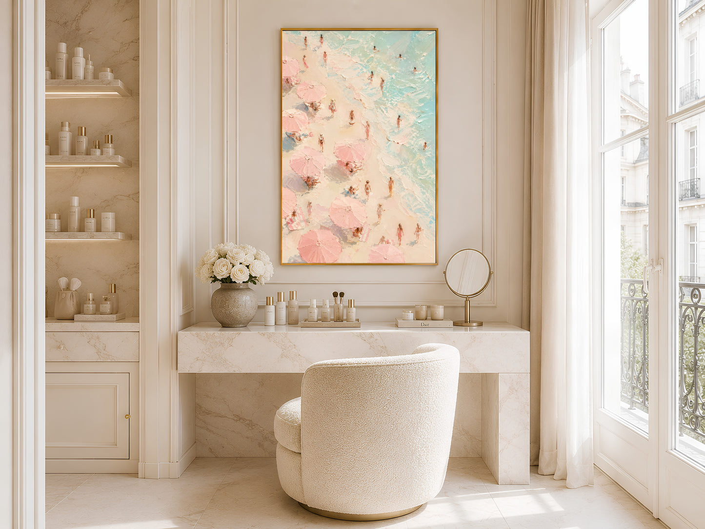 Pink aerial beach scene wall art in gold frame above a marble bathroom vanity in a bright minimal neutral bathroom