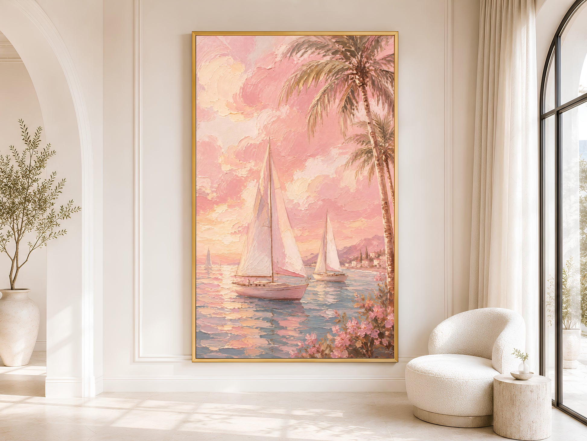 Pink sailboat coastal wall art in gold frame in a bright neutral living room with arched doorway and olive tree