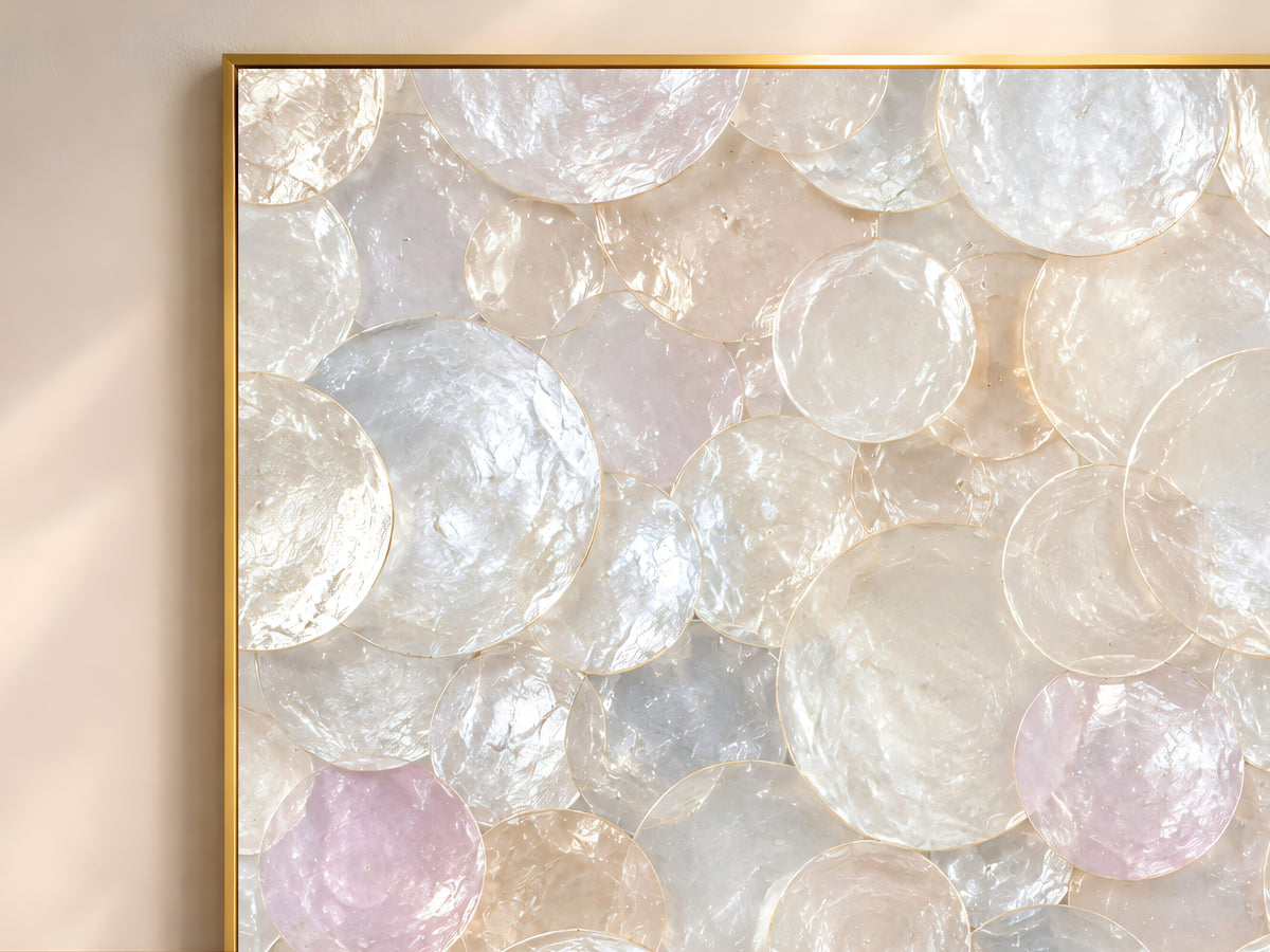 Close-up of the pastel iridescent capiz shell wall art showing blush, lavender, and pale blue shell discs