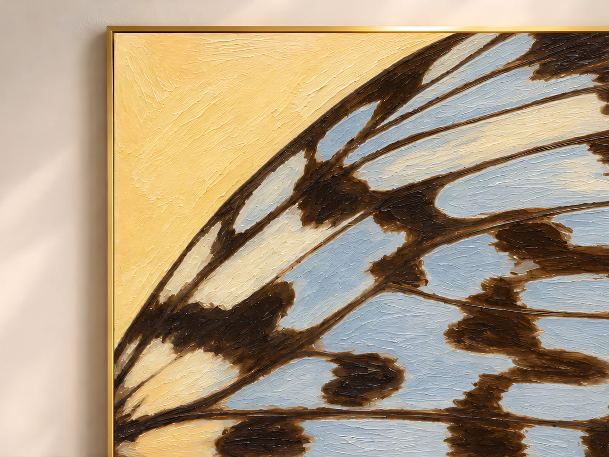 Close-up of textured impasto butterfly wing print in butter yellow and dusty blue showing raised brushstroke detail
