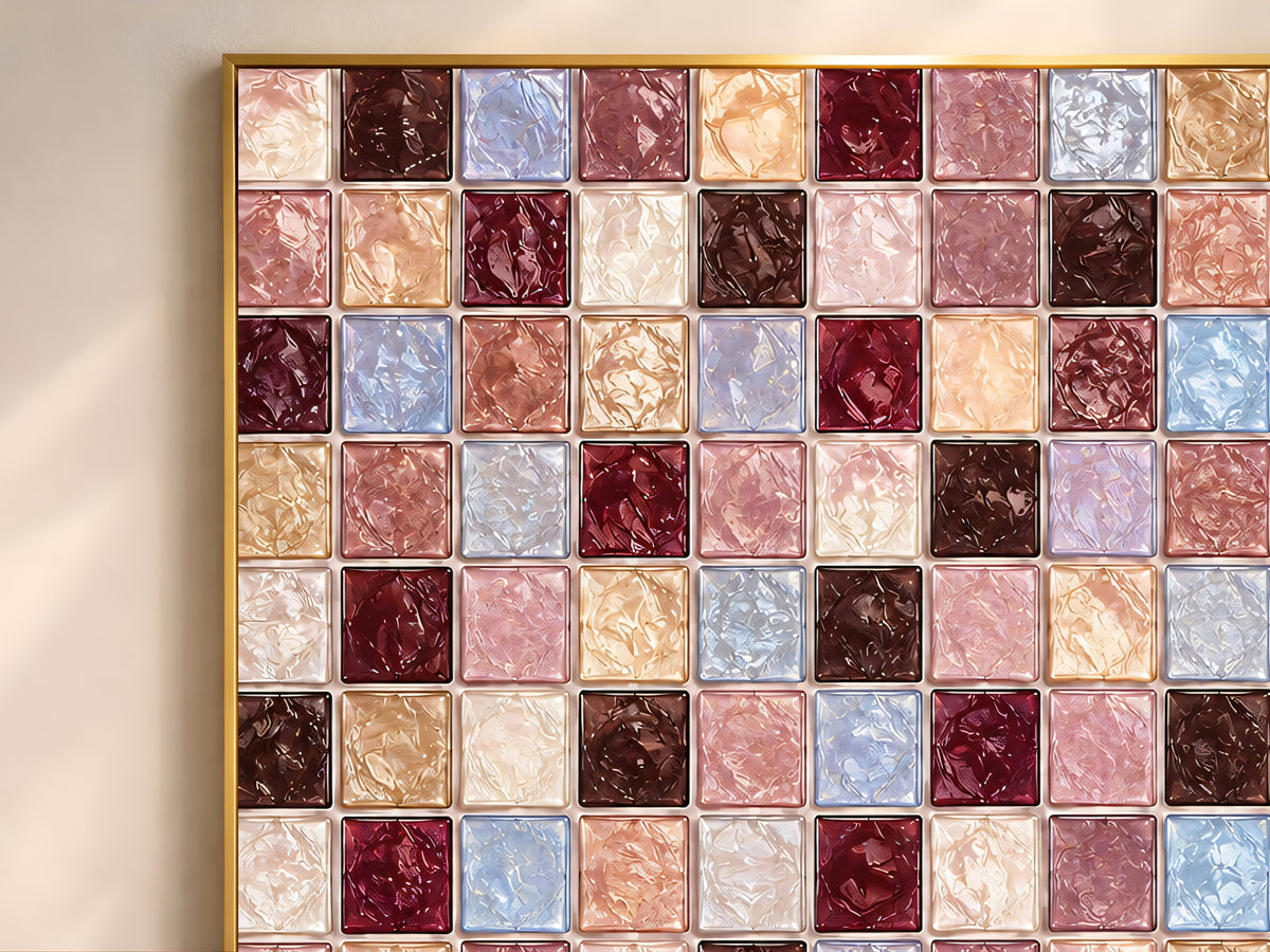 Close-up of geometric mosaic wall art in burgundy, mauve, dusty blue, and cocoa glass-tile pattern