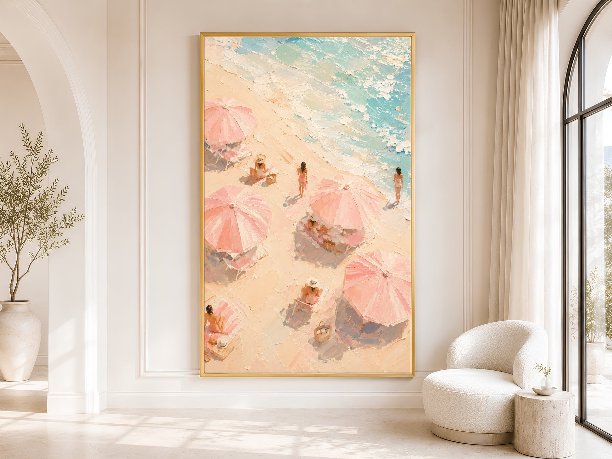 Pink beach umbrella wall art in gold frame displayed in a bright neutral living room with arched doorway and olive tree

