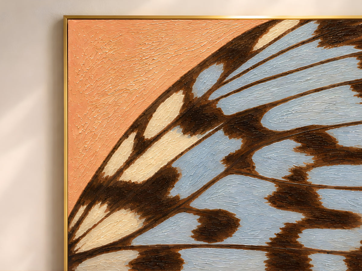 Close-up of textured impasto butterfly wing print in terracotta and dusty blue showing raised brushstroke detail