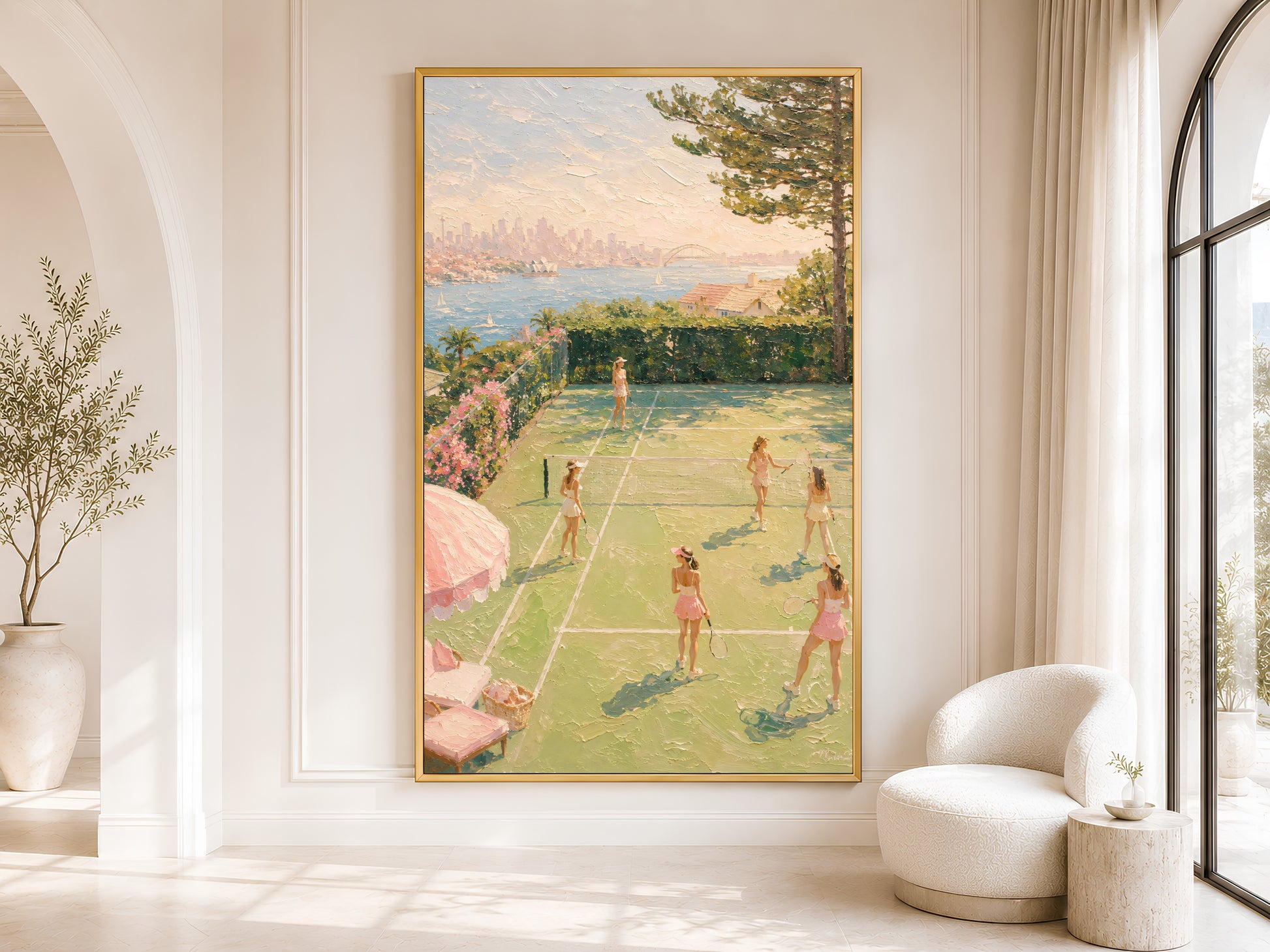 Pink tennis wall art in gold frame displayed in a bright neutral living room with arched doorway and olive tree