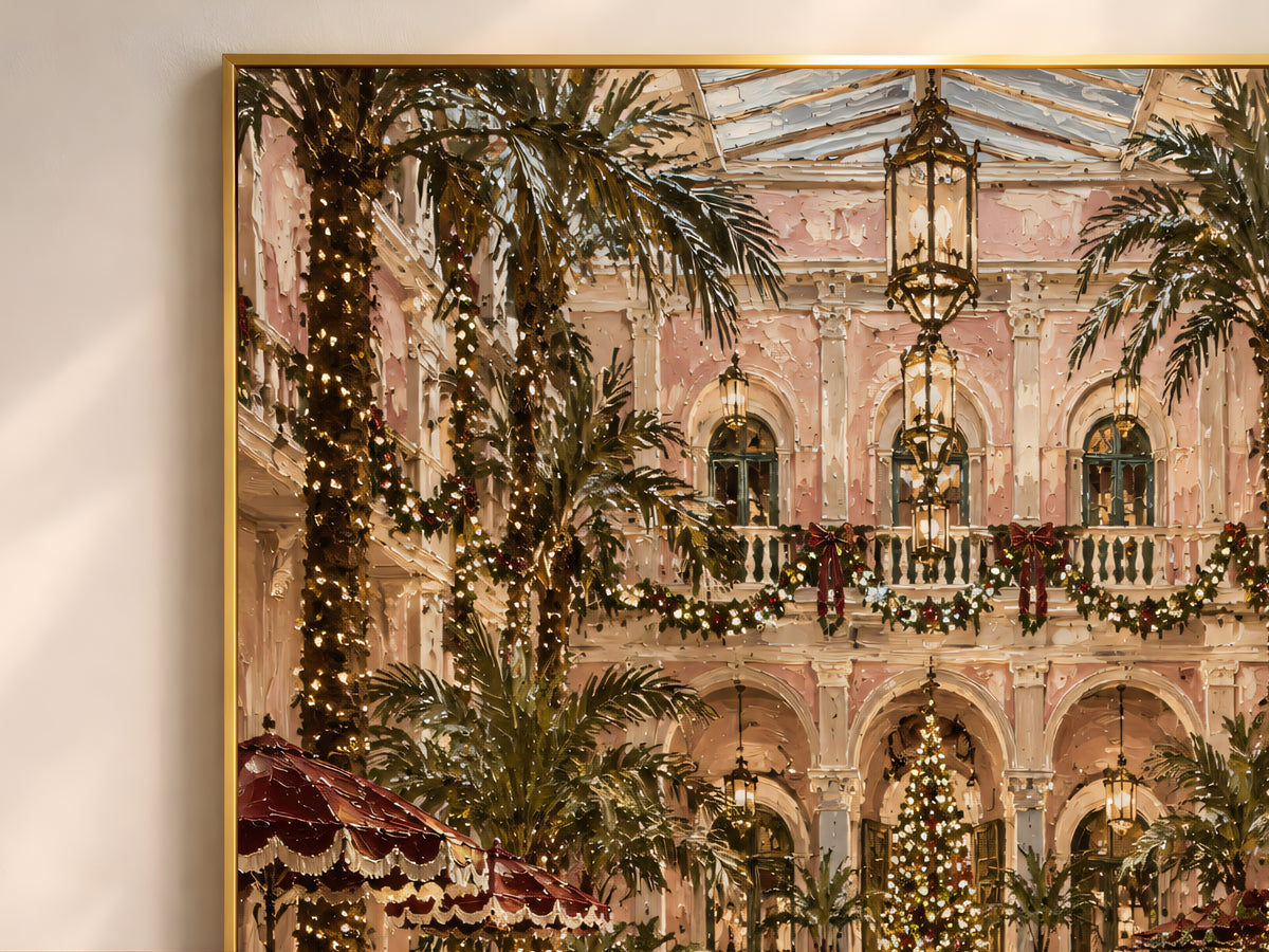 Close-up of the grand hotel Christmas painting showing palm trees, string lights, and a glowing atrium