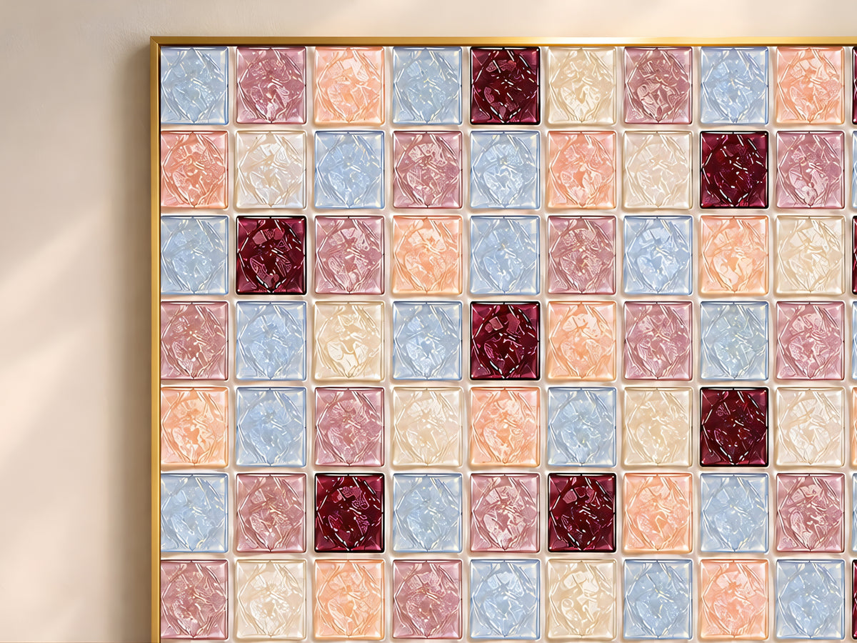 Close-up of geometric mosaic wall art in peach, powder blue, burgundy, and cream glass-tile pattern