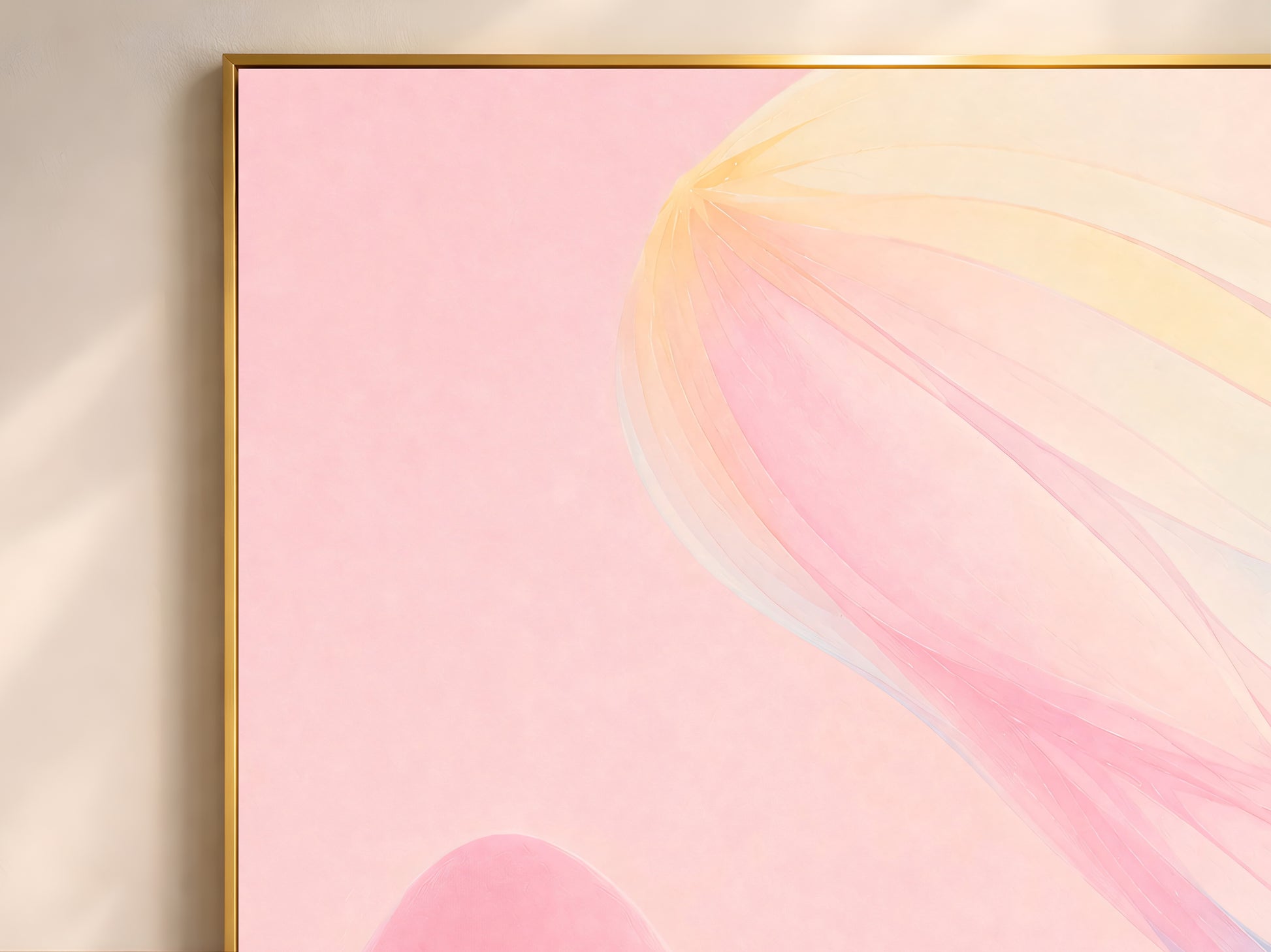 Close-up of ethereal pastel ribbon abstract print in a thin gold frame on a blush pink wall
