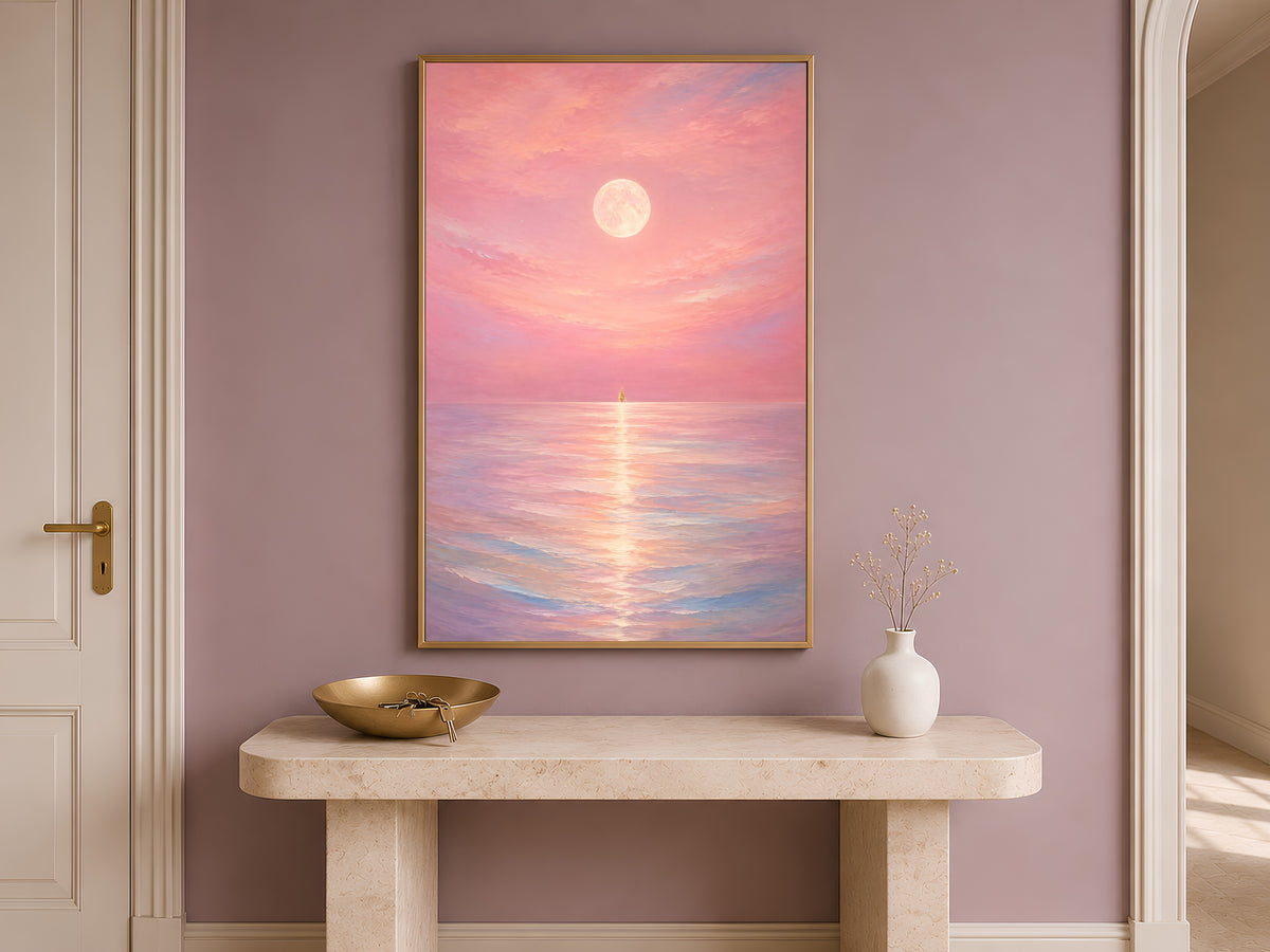 Pink moon ocean wall art framed on a wall above an entryway console table with a bowl
