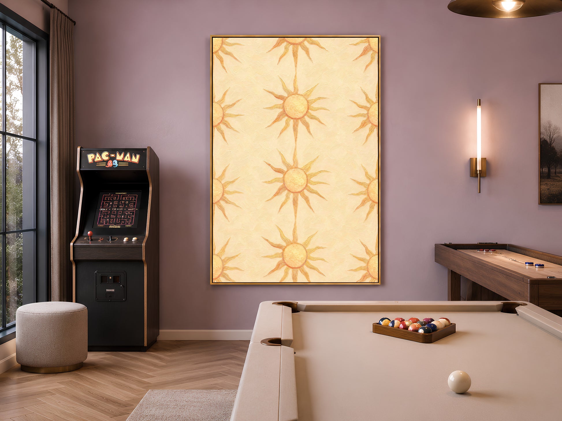 Butter yellow sun motif print framed in a game room with an arcade machine and pool table
