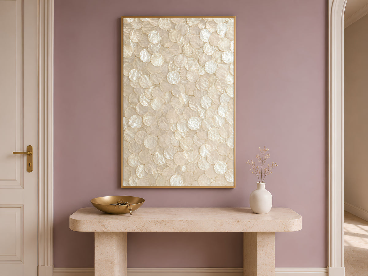 Capiz shell wall art print above a mauve entryway console table