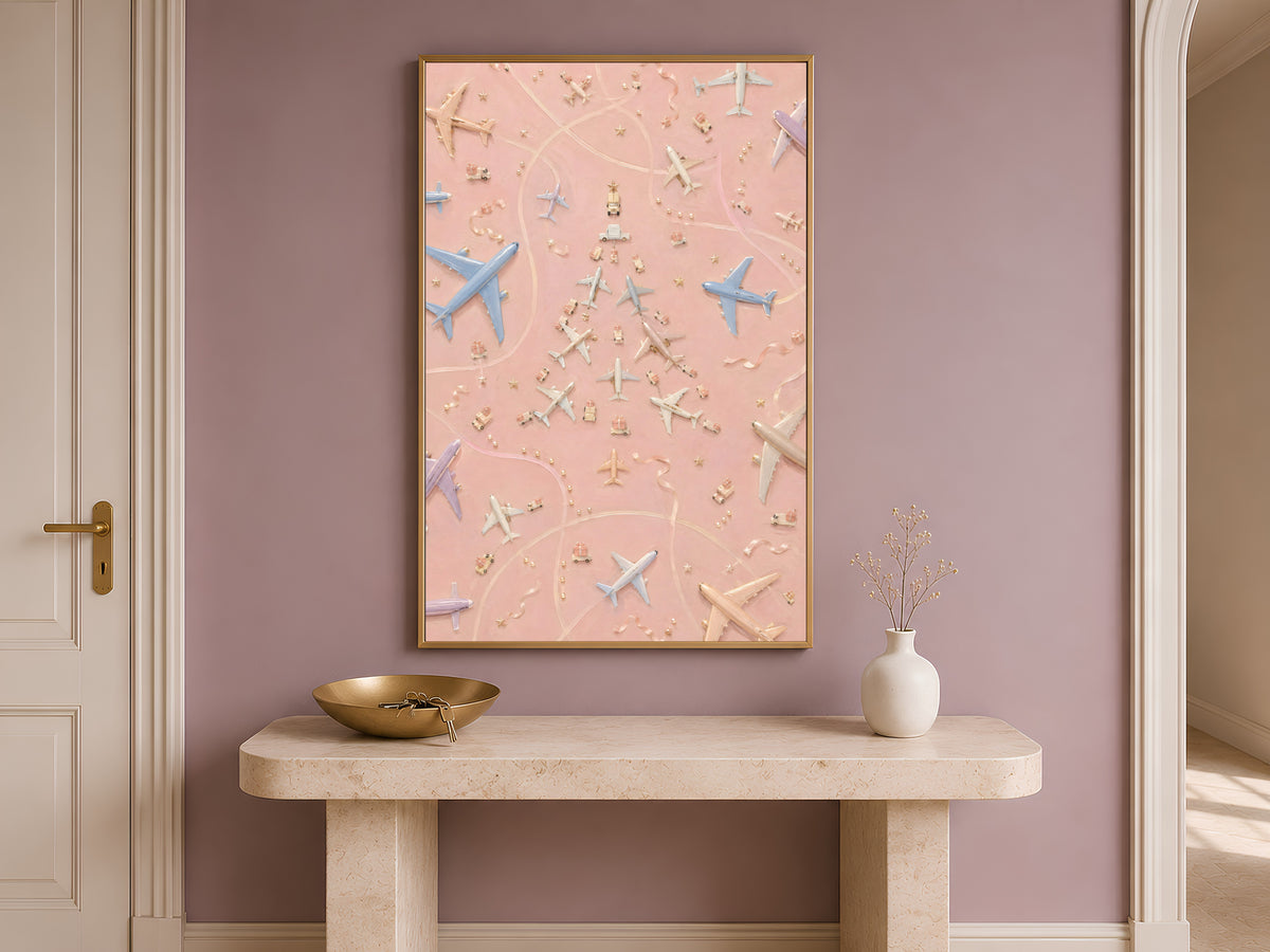 Framed airplane Christmas tree print above a console table in a warm neutral entryway
