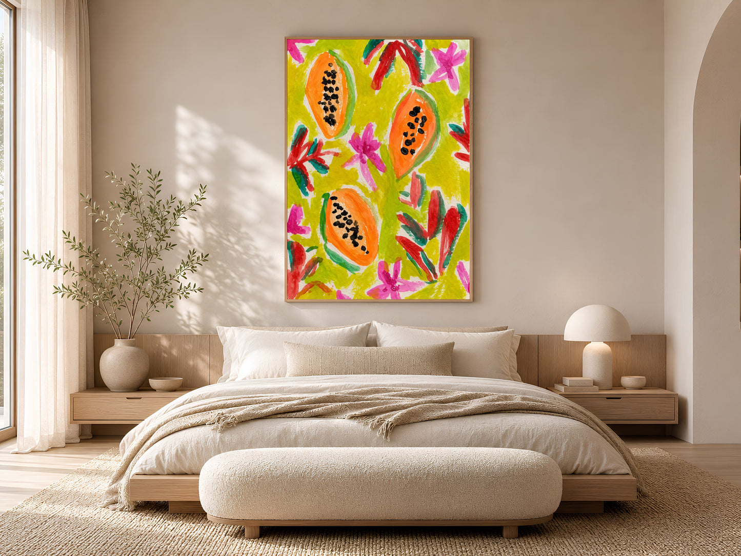 Colorful papaya print in a gold frame displayed in a warm beige bedroom with a low platform bed, linen bedding, and soft natural light

