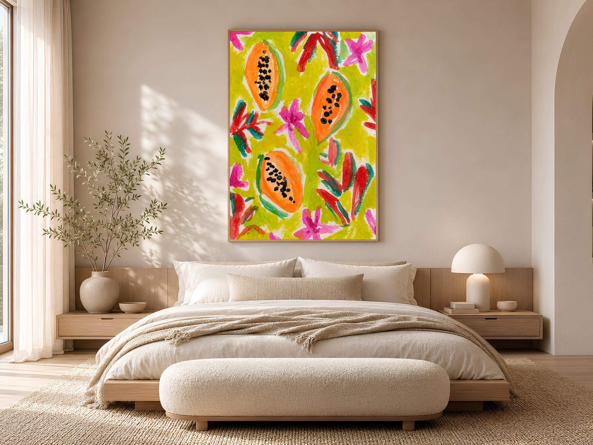 Colorful papaya print in a gold frame displayed in a warm beige bedroom with a low platform bed, linen bedding, and soft natural light
