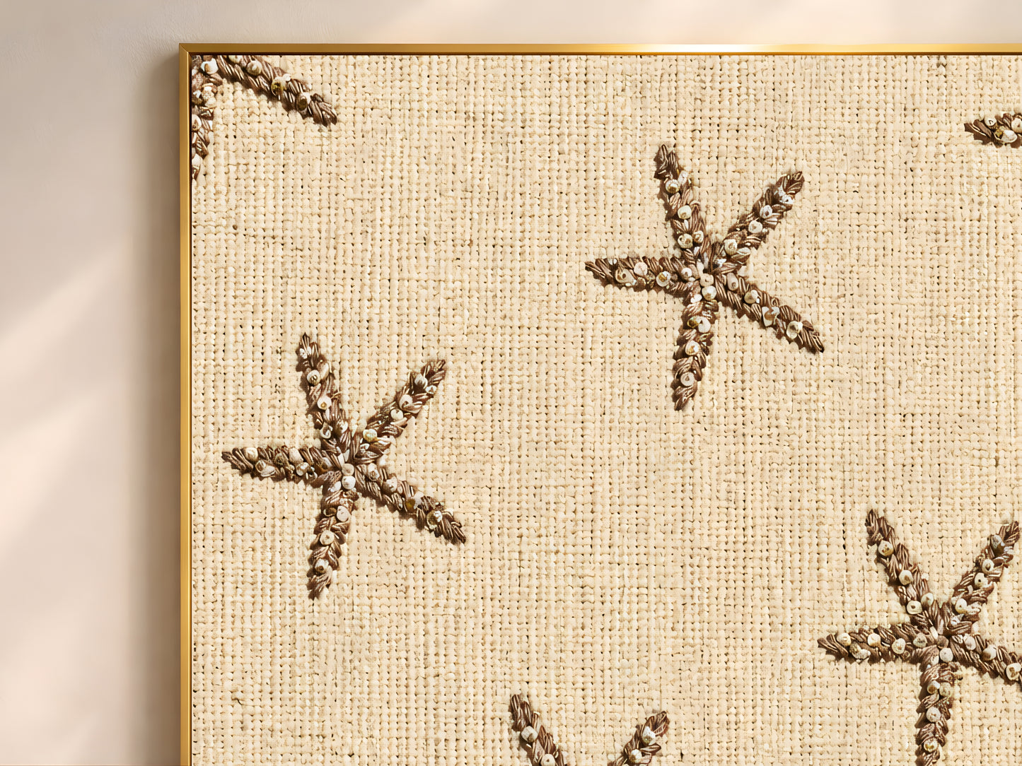 Close-up of embroidered starfish print showing beaded brown starfish on natural linen texture