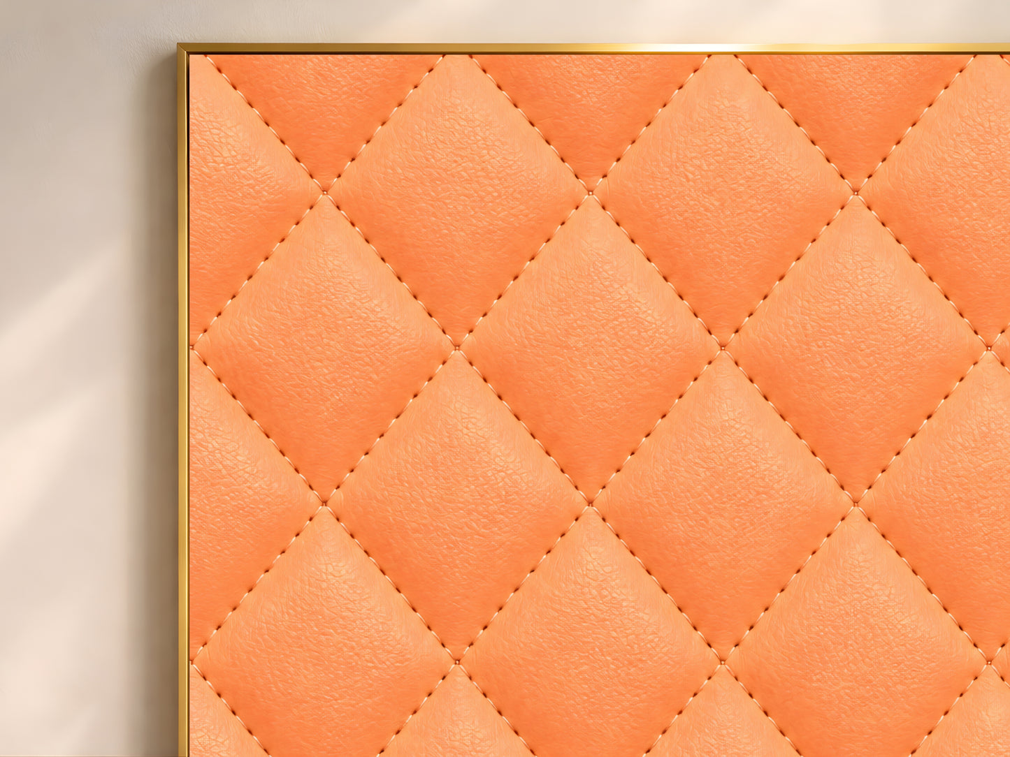 Close-up of quilted leather print showing coral orange diamond-stitched texture
