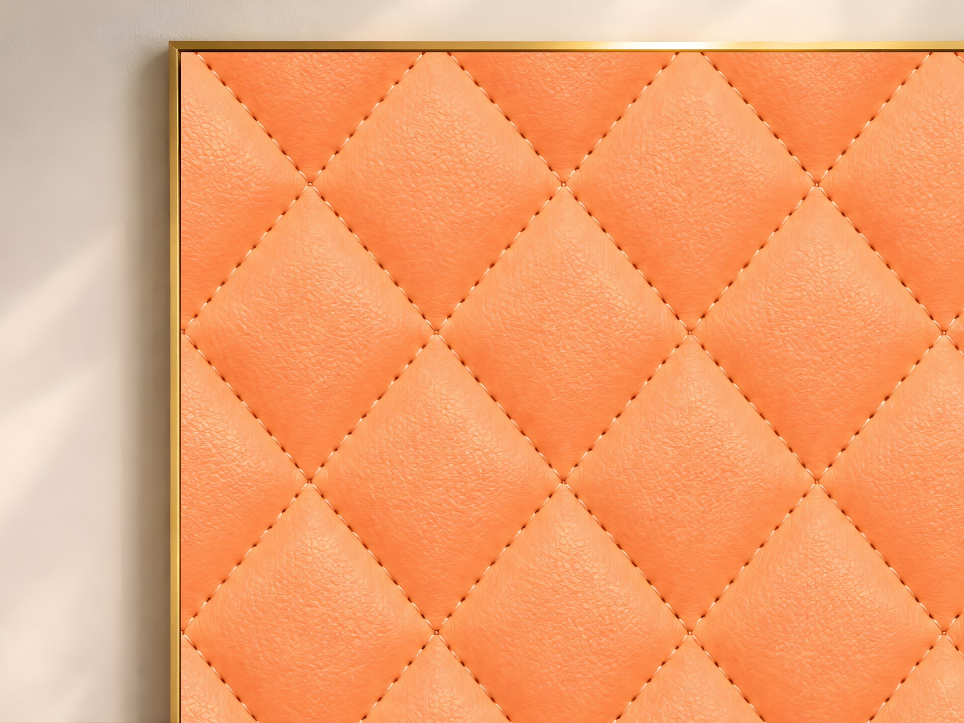 Close-up of quilted leather print showing coral orange diamond-stitched texture