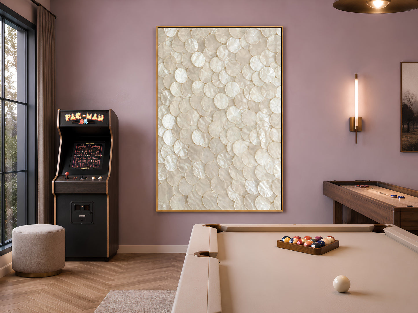 Capiz shell mosaic art framed in a game room with an arcade machine and pool table


