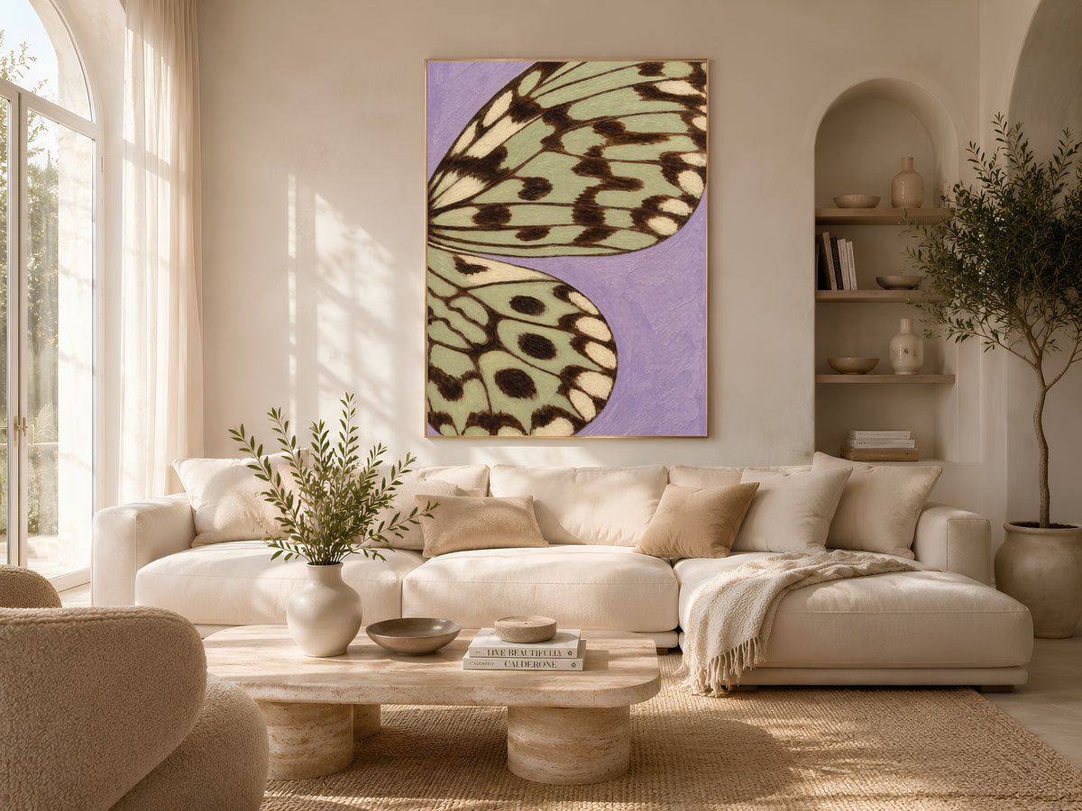 Lavender and sage green butterfly wing art framed on a wall in a cozy neutral living room