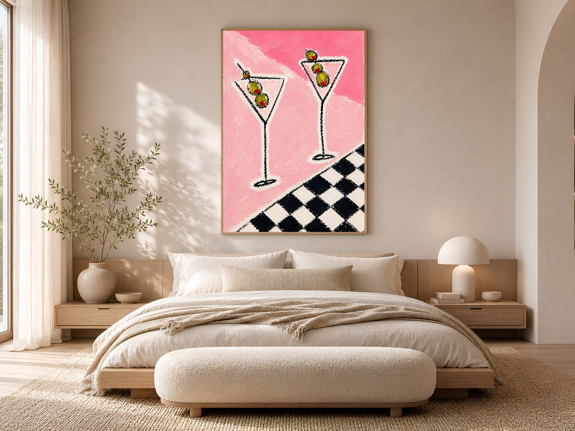 Framed impasto martini print on warm white wall above low platform bed in neutral minimal bedroom with cream bedding

