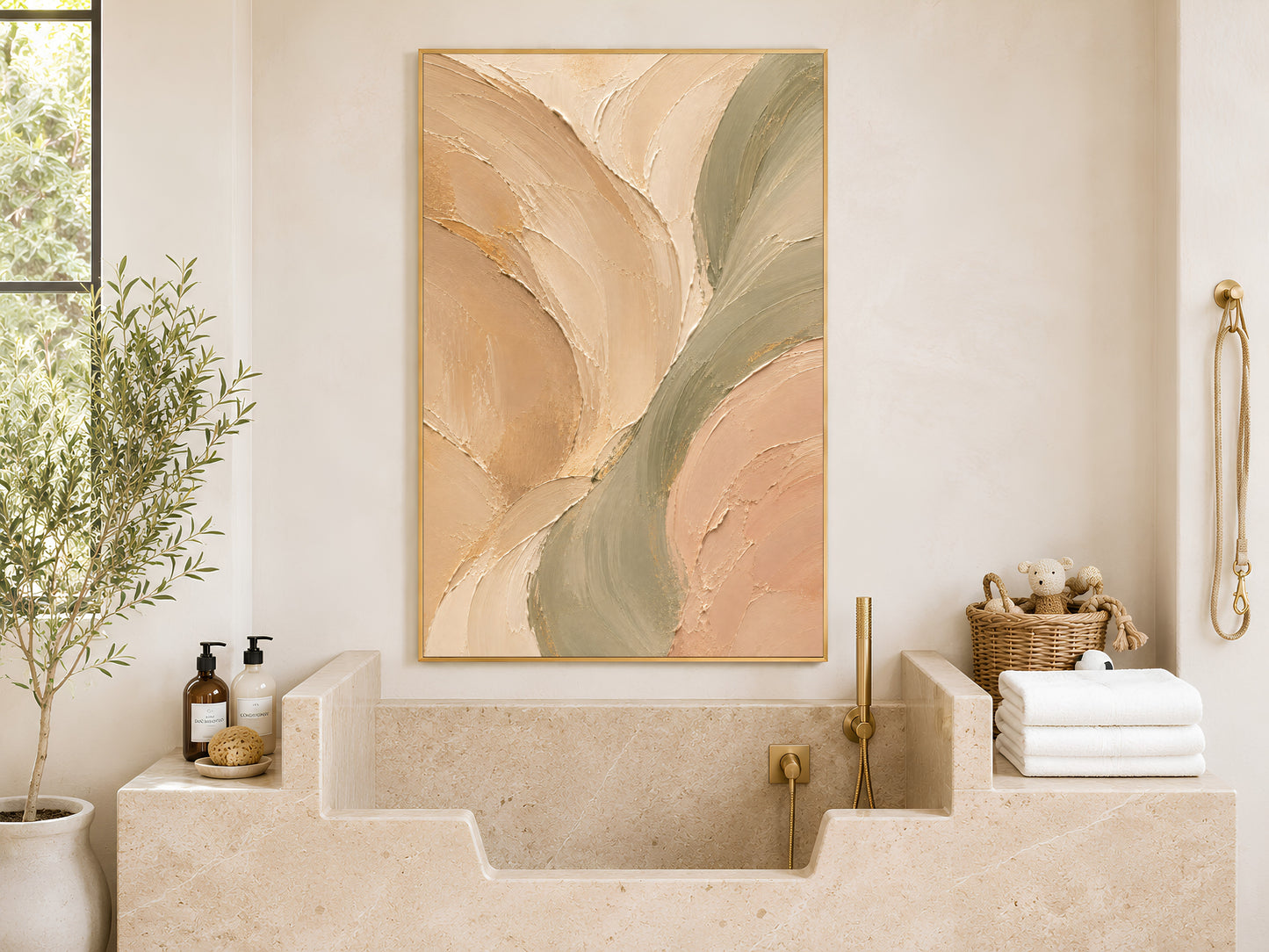 Sage green beige abstract wall art in gold frame in bright bathroom with neutral stone tiles and toiletries

