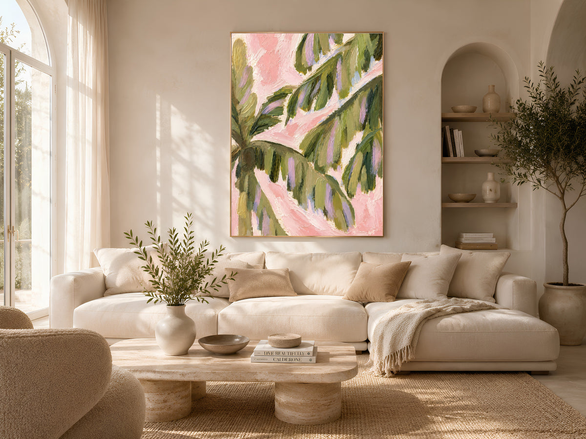 Preppy palm leaf wall art above a neutral boucle living room sofa