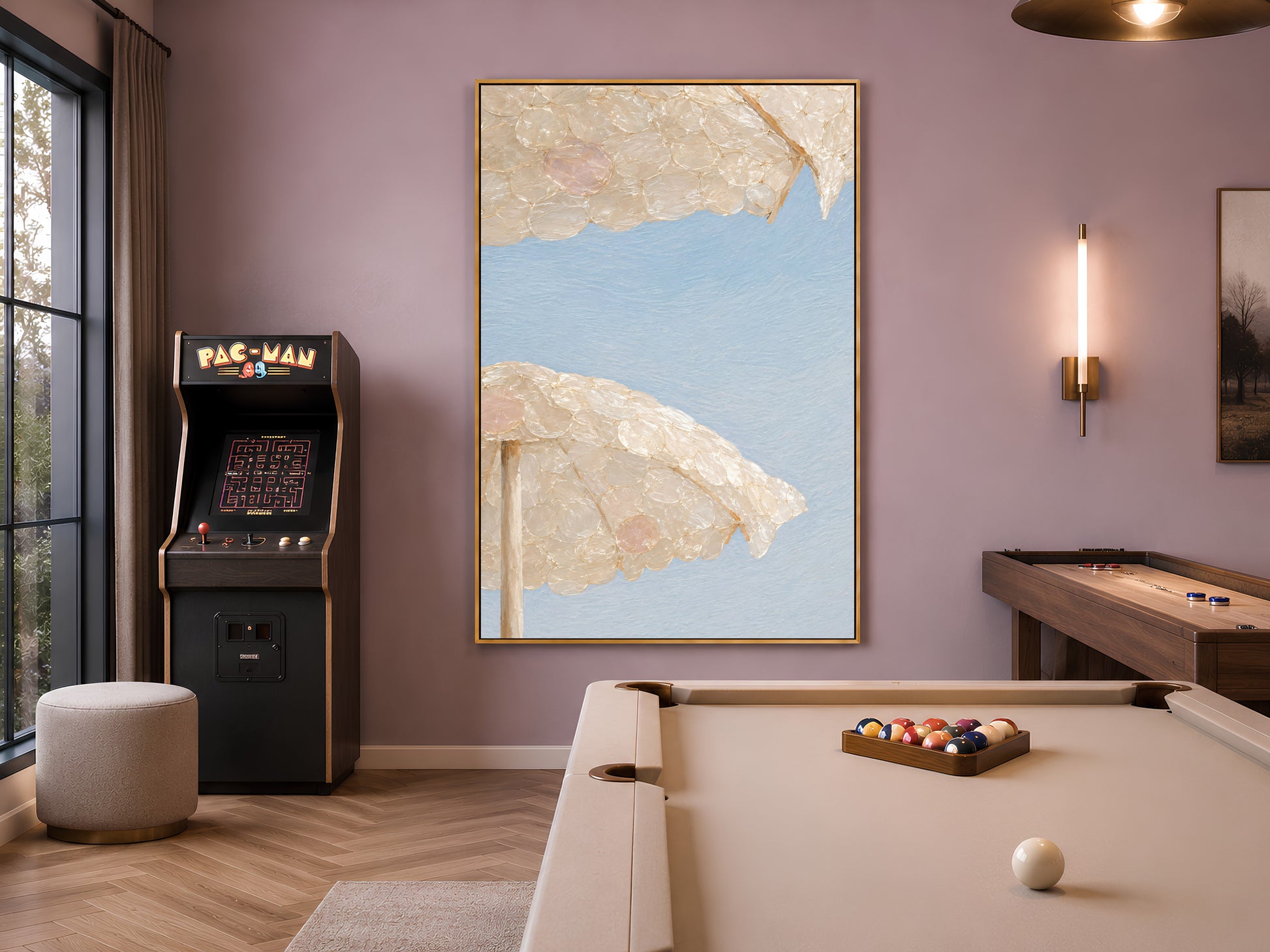 Capiz shell beach umbrella art framed in a game room with an arcade machine and pool table
