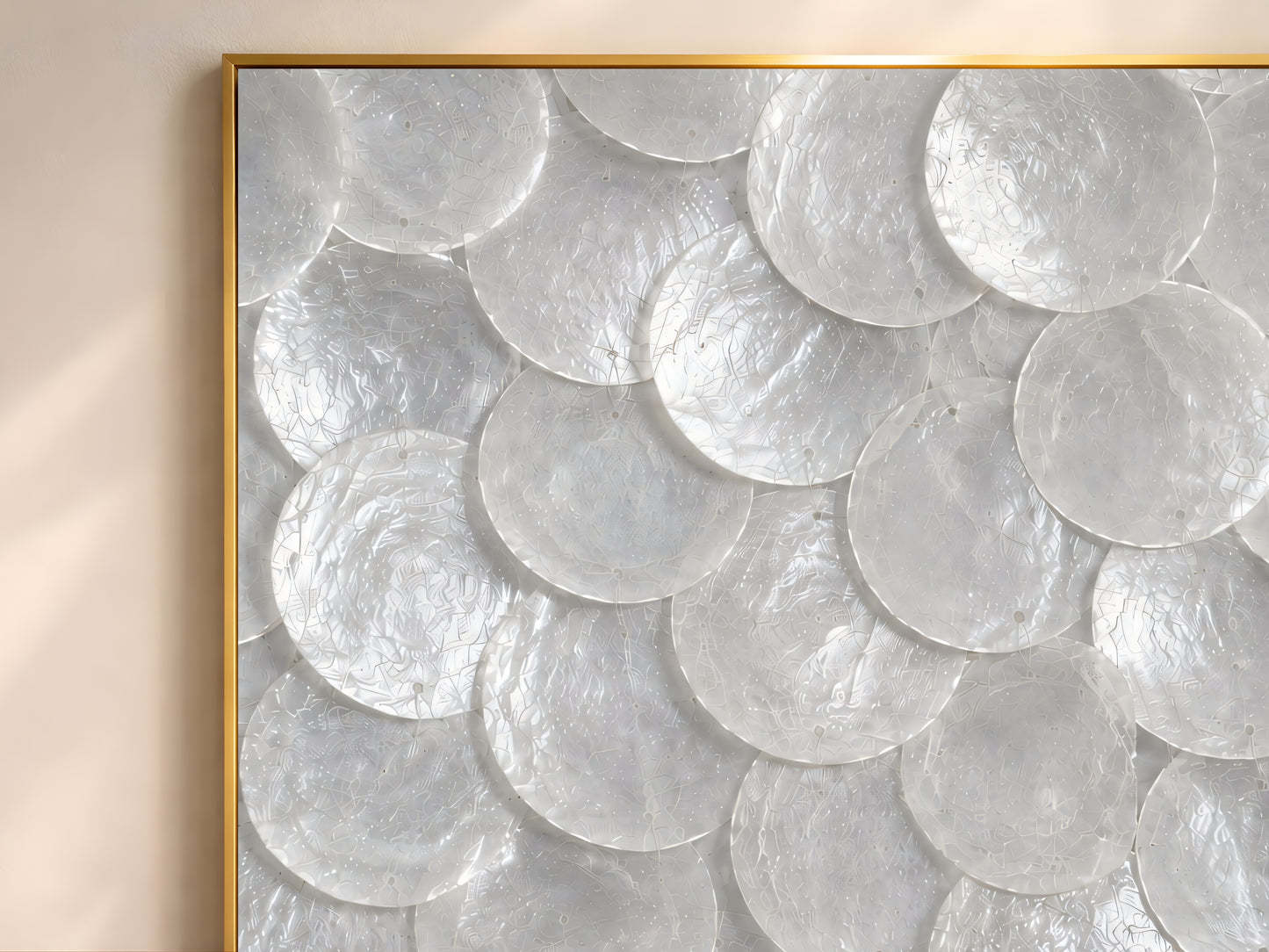 Close-up of white capiz shell mosaic artwork showing pearl and ivory shell texture.
