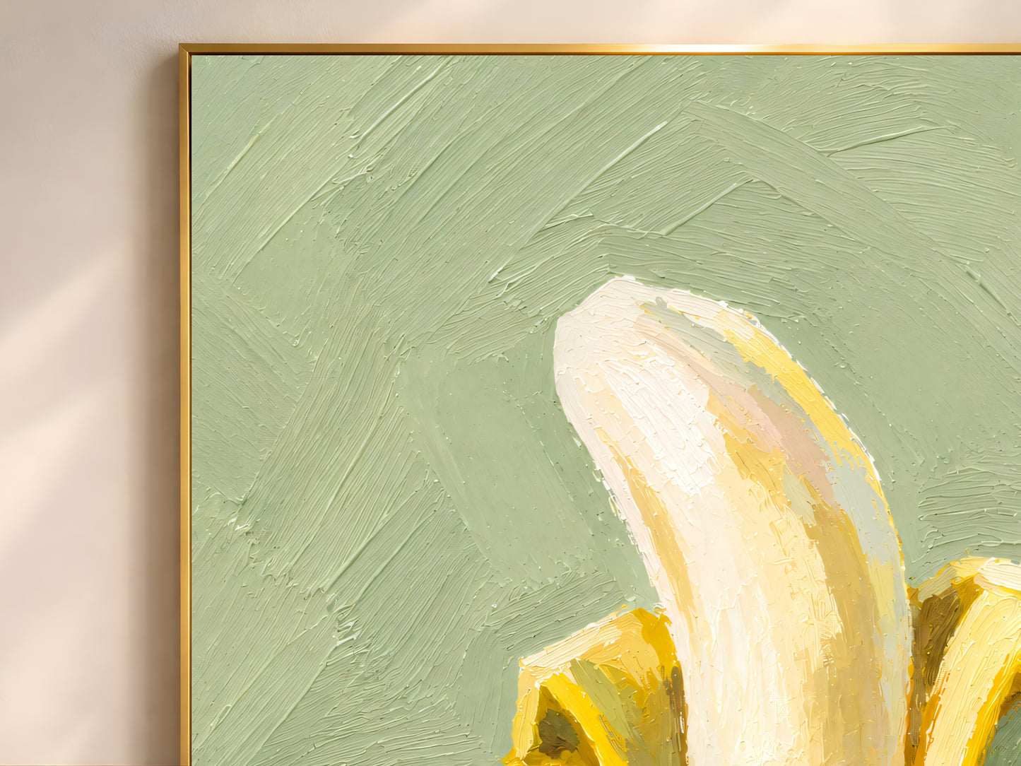 Close-up gold frame corner on banana still life oil painting print, sage green background wall art