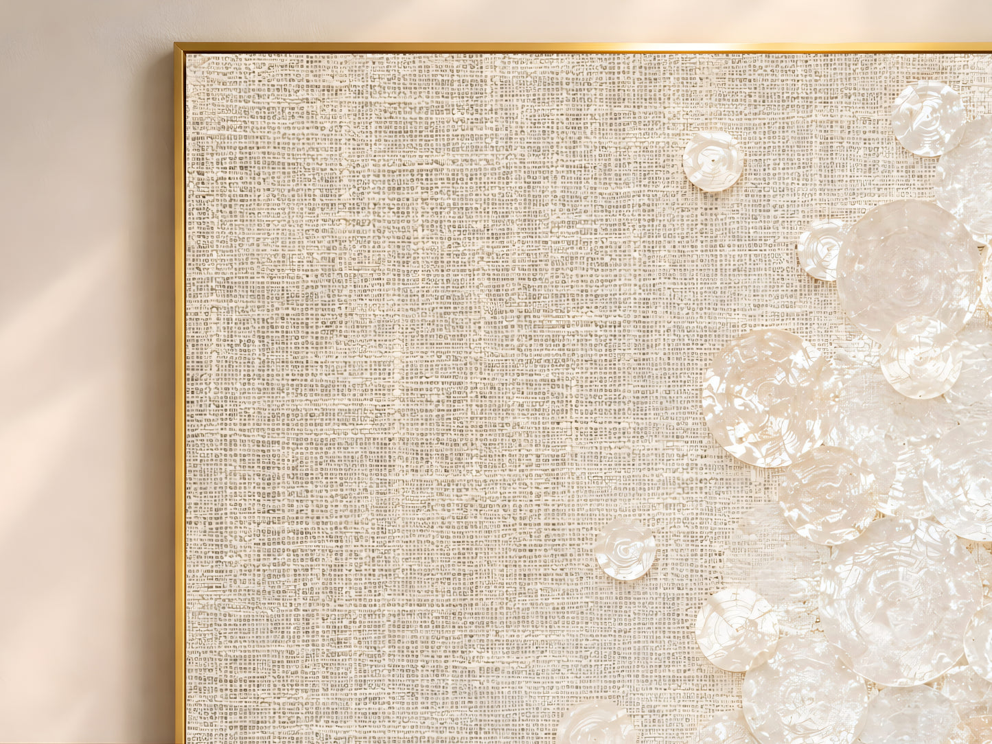 Close-up detail of capiz shell clusters on woven linen texture in ivory and cream tones
