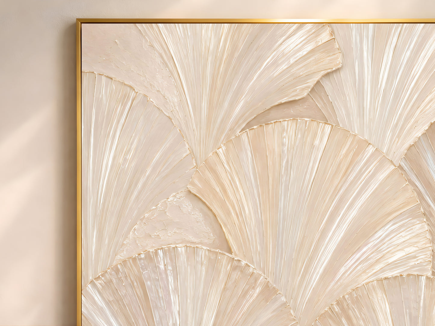 Close-up of capiz shell wall art in a gold frame, showing the sculptural fan texture and iridescent mother-of-pearl highlights.
