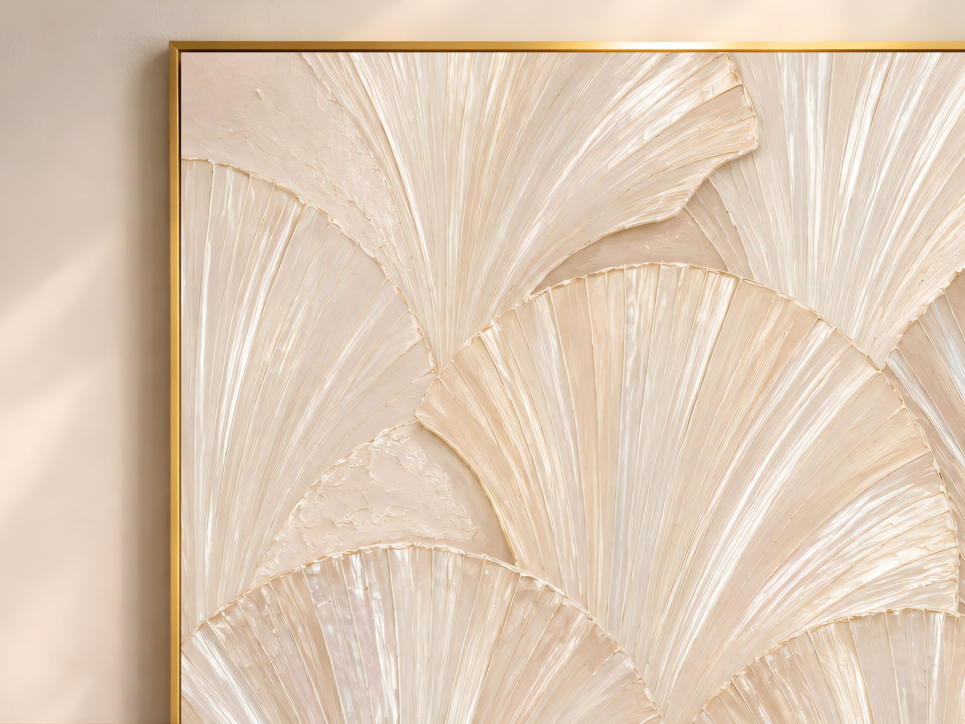 Close-up of capiz shell wall art in a gold frame, showing the sculptural fan texture and iridescent mother-of-pearl highlights.
