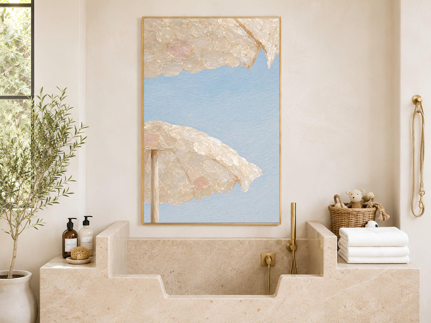 Capiz shell beach umbrella wall art framed above a stone bathtub and folded towels

