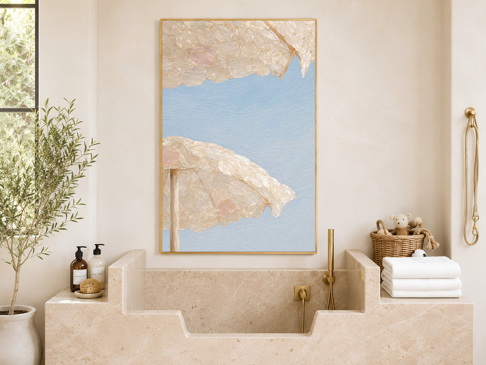 Capiz shell beach umbrella wall art framed above a stone bathtub and folded towels

