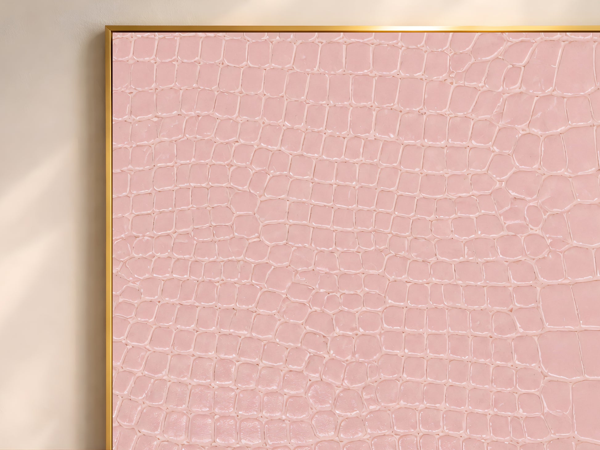 Close-up of pink crocodile leather texture print showing its scaled, tactile pattern.
