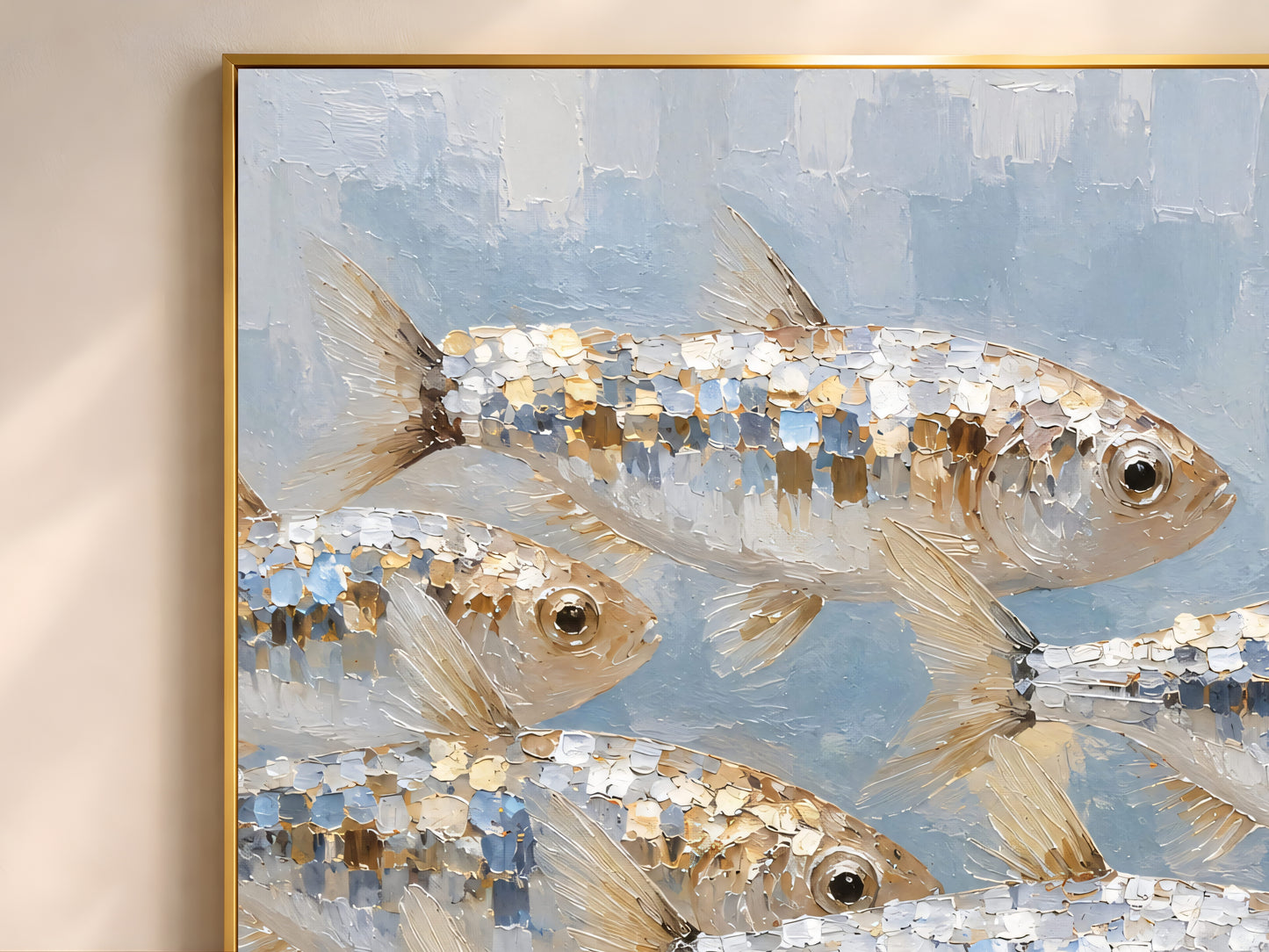 Close-up of school of fish wall art in a thin gold frame, textured impasto oil painting in silver, gold, and blue