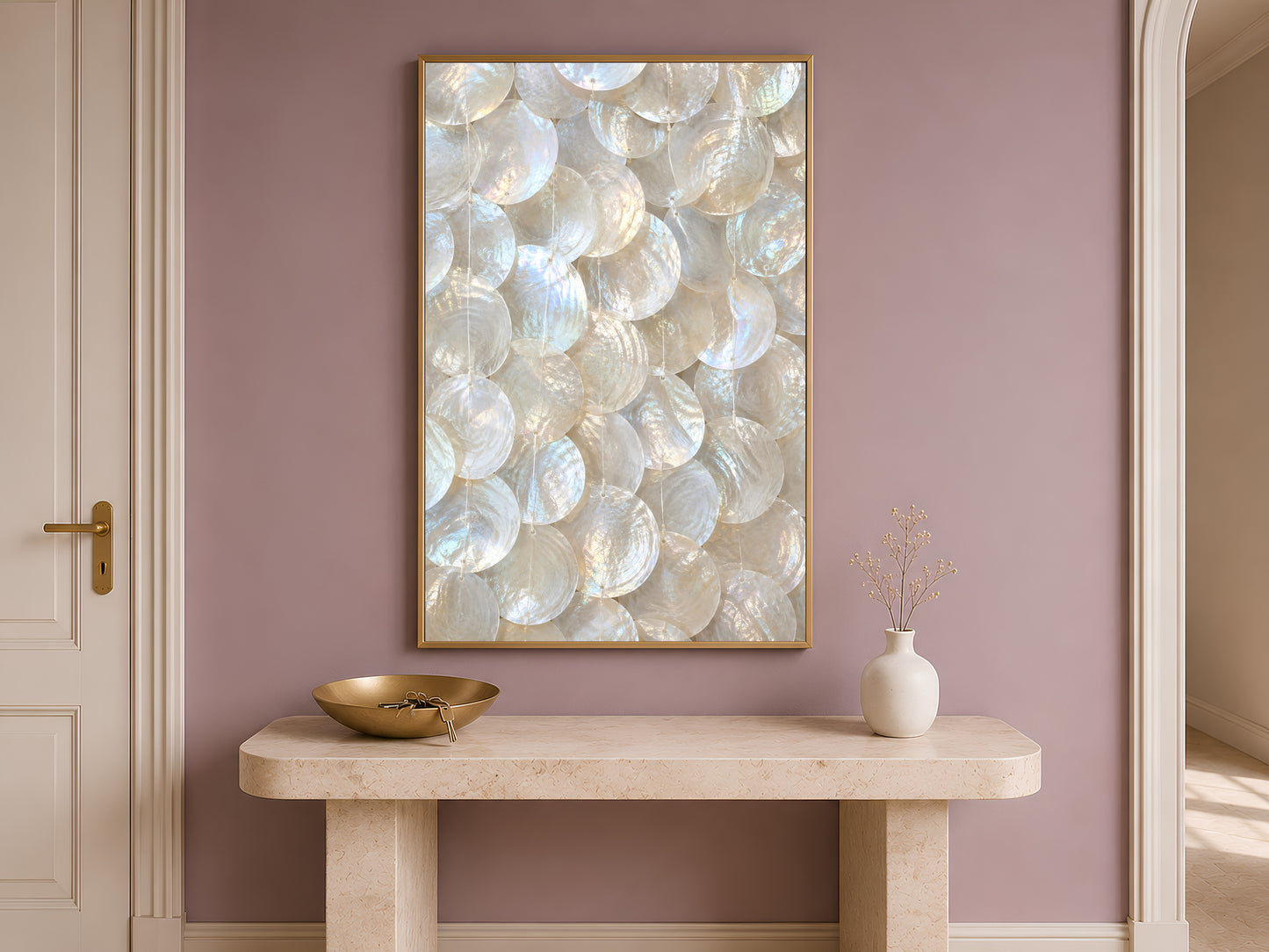 Framed capiz shell wall art print above a console table against a mauve wall.

