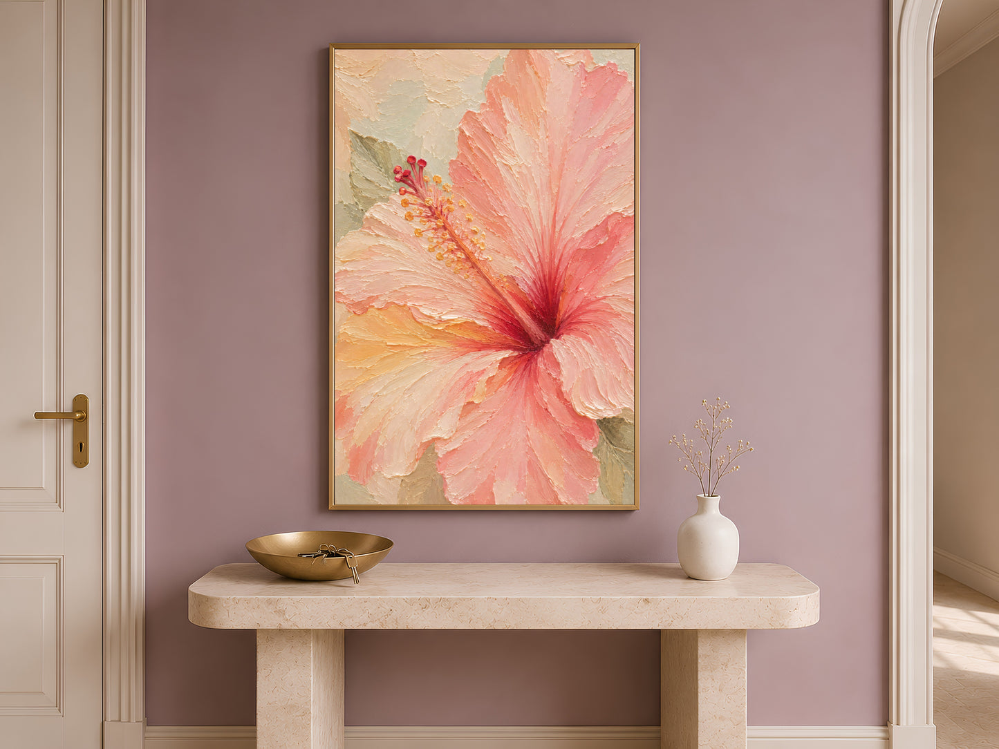 Framed hibiscus wall art above a console table in a bright Mediterranean-style entryway