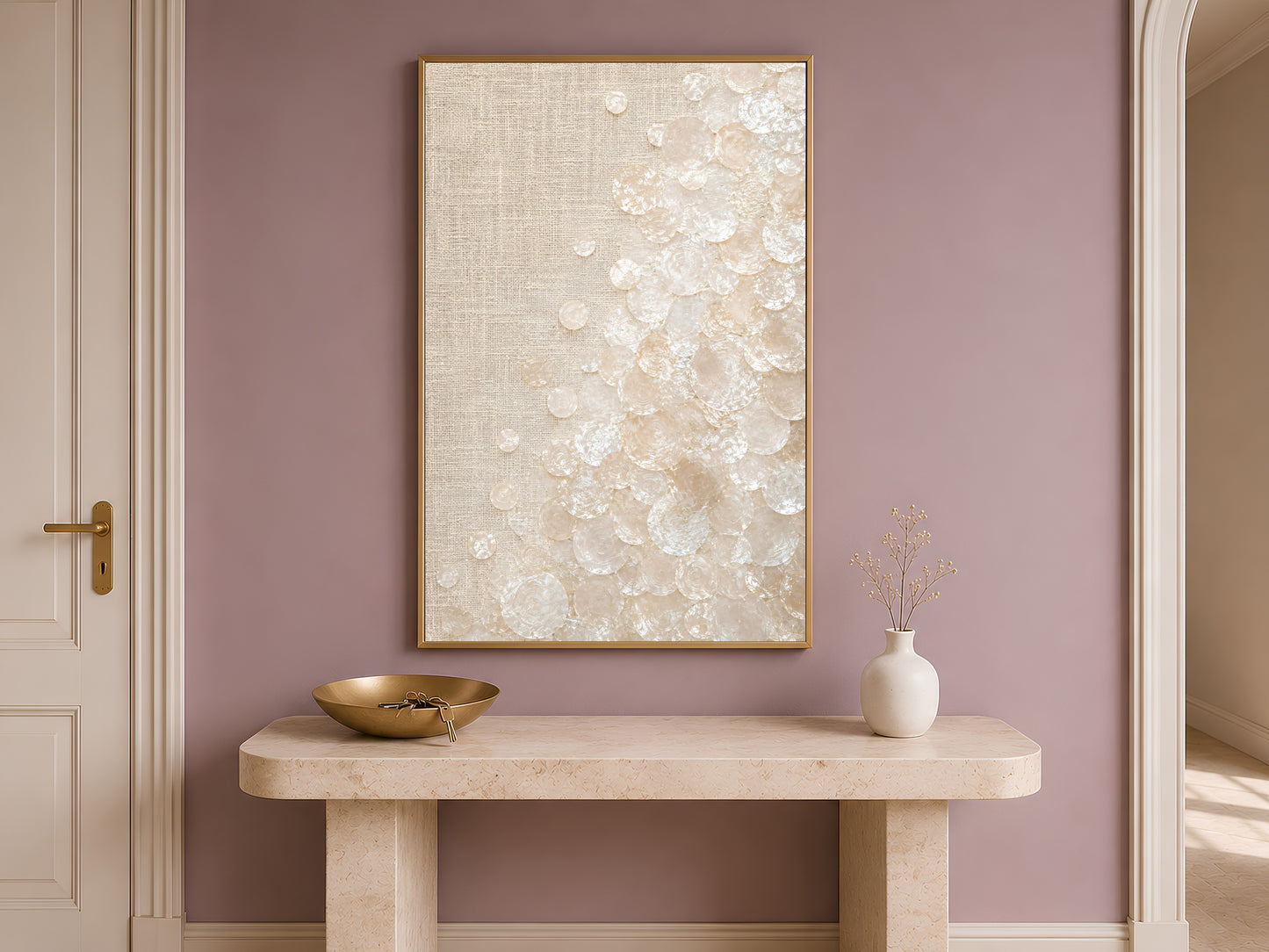 Capiz shell wall art print in a gold frame above a console table in a mauve entryway
