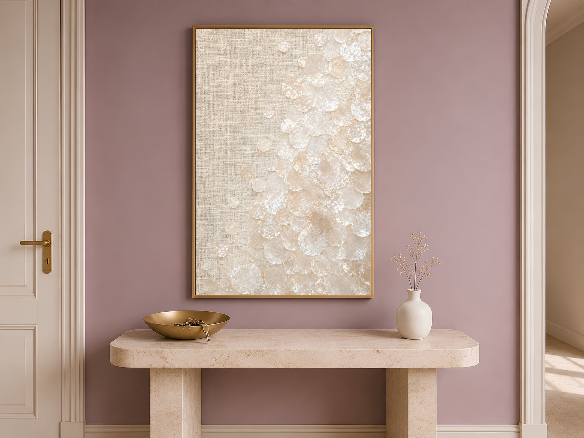 Capiz shell wall art print in a gold frame above a console table in a mauve entryway
