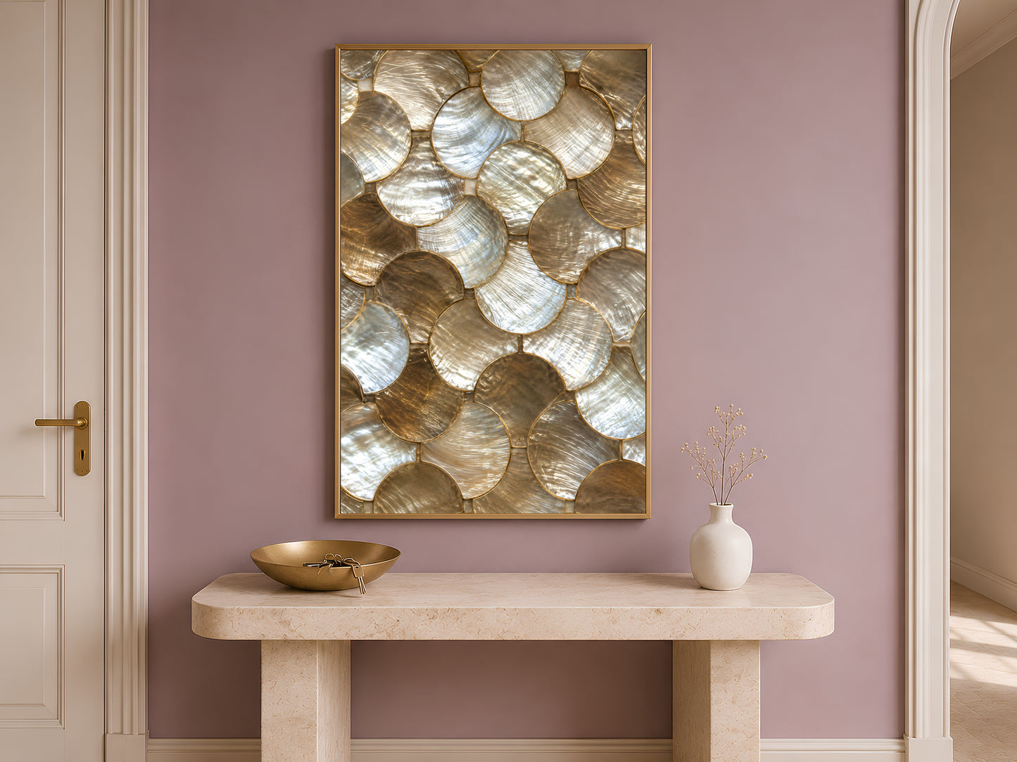 Gold abstract wall art print in a gold frame above a console table against a mauve wall.
