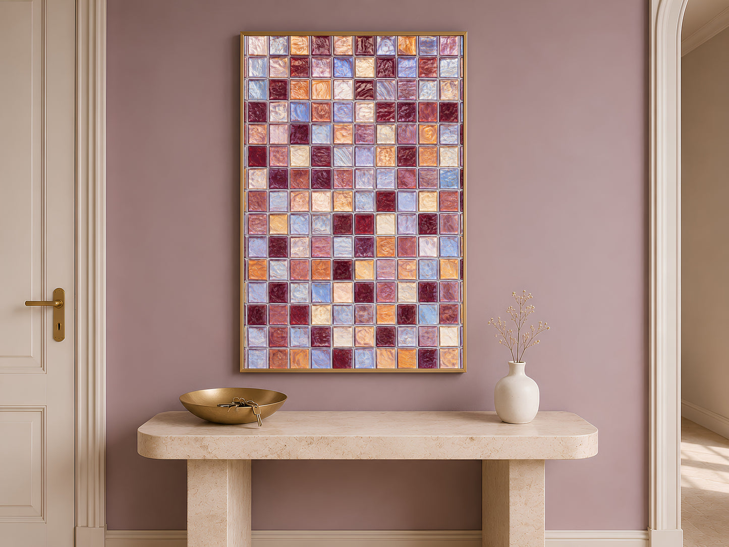 Mosaic tile wall art above a console table in an entryway, styled with a small bowl and vase.
