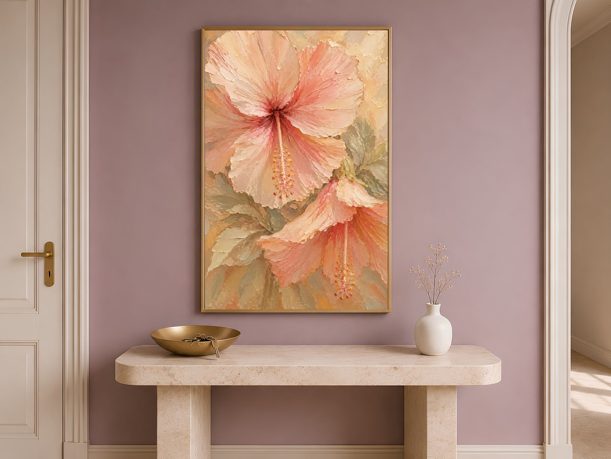 Hibiscus flower print in a gold frame above a console table in a neutral entryway