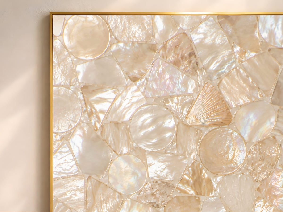 Close-up of mother of pearl and shell mosaic texture in ivory, champagne, and cream tones