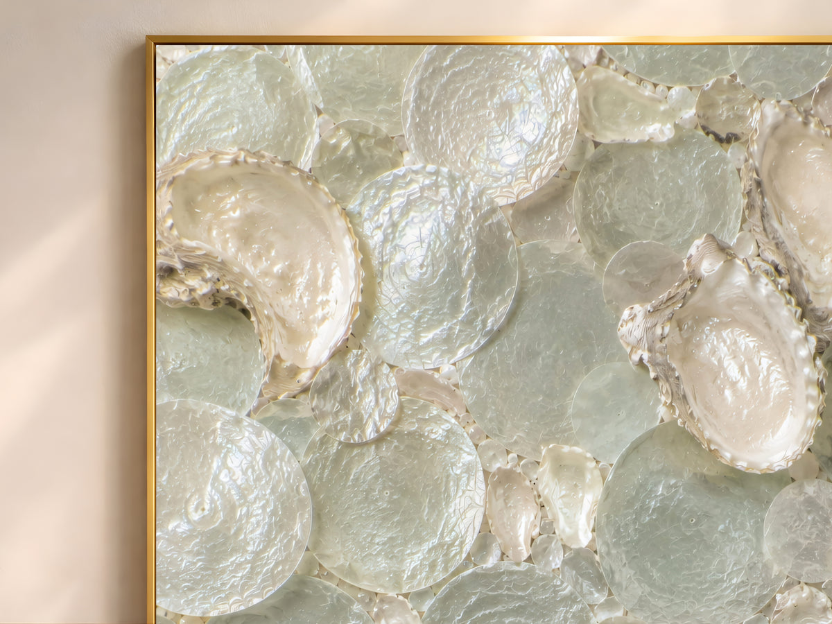 Close-up of sea glass and oyster shell mosaic texture in sage green, cream, and pearl tones