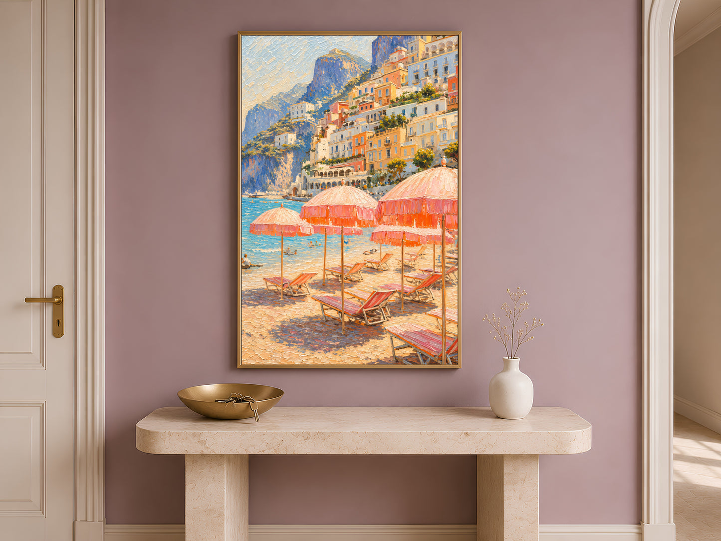 Entryway with a wooden console table and dried florals, framed Positano beach umbrellas print hanging on a dusty mauve wall.
